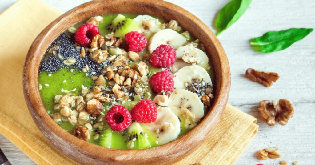 Creamy Green Protein Power Smoothie Bowl with Berries and Almonds